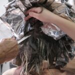 Close-up of a hairdresser applying color with foils in a salon, İzmir.
